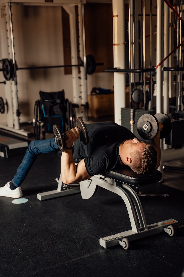 Man Lifting Weights While Lying Down