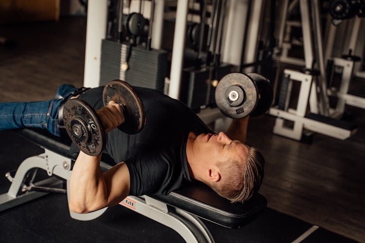 A Man Doing A Dumbbell Chest Press