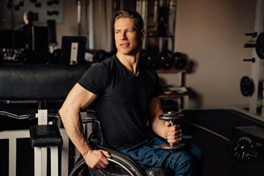 A muscular man in a wheelchair lifting a dumbbell indoors, showcasing determination and fitness.