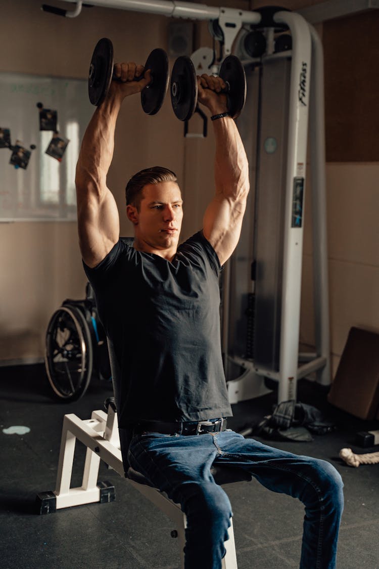 A Man Doing A Dumbbell Shoulder Press