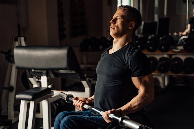 A Man Holding A Barbell