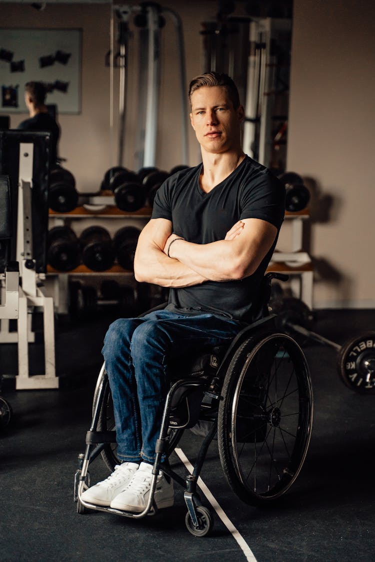 A Man In A Wheelchair While In A Training Facility