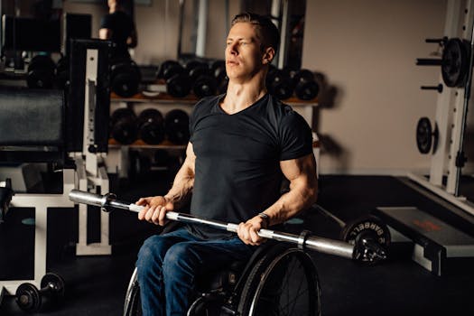 Adaptive athlete in a gym demonstrating strength and determination with barbell exercise.