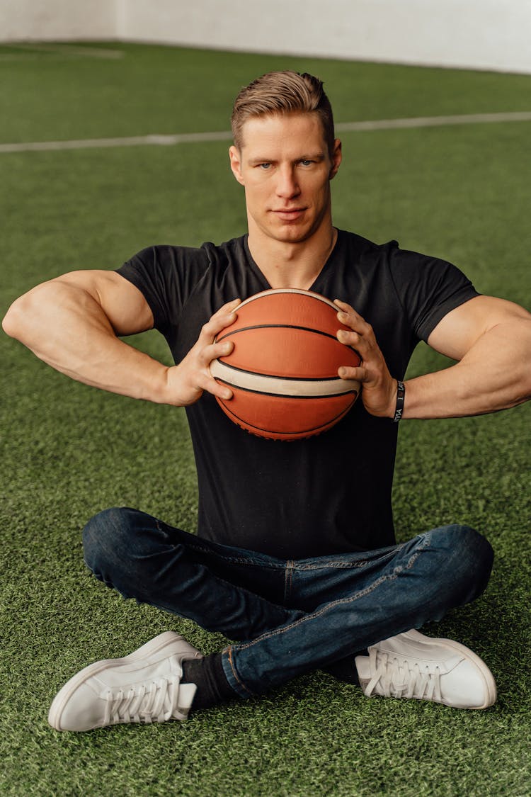 A Man In Black Shirt Holding Basketball