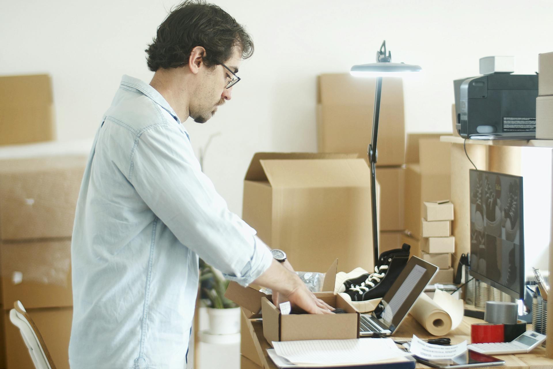 Businessman packing products in a home office for an online store startup.