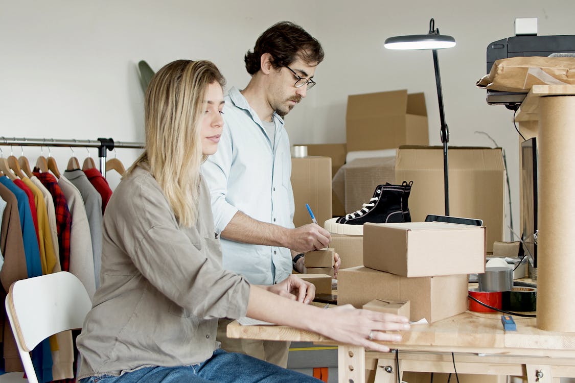 Free Couple Busy with Packaging Their Products Stock Photo