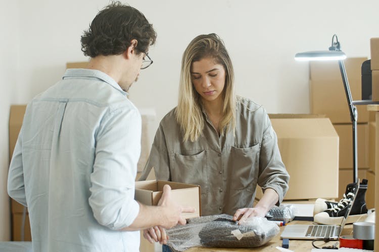 Woman Using Bubble Wrap On Wrapping The Product