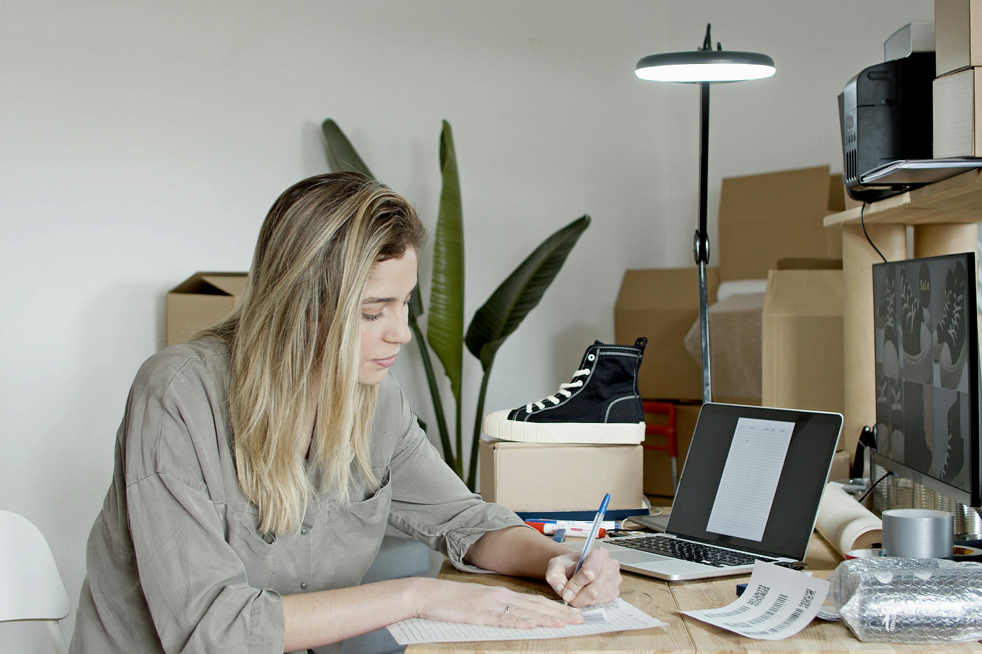 woman busy writing on the paper