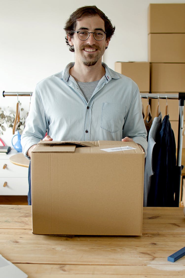 Man Smiling While Holding The Package