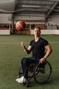 Man in Black Crew Neck T-shirt and Blue Denim Jeans Sitting on Black Wheelchair