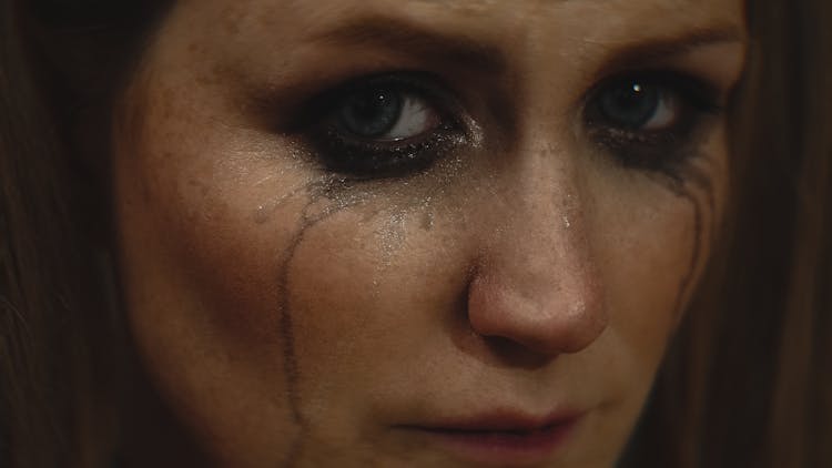 Close Up Photo Of Crying Woman With Messy Eyeliner