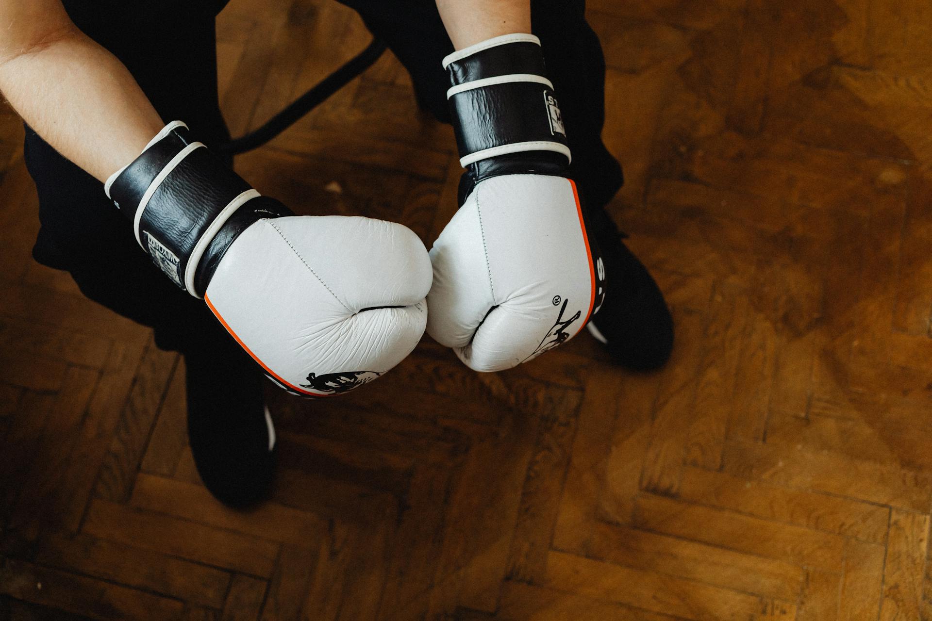 A Person Wearing a Black and White Boxing Gloves