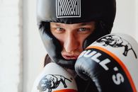 Man in White and Black Headgear with Bull's Boxing Gloves