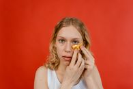 Woman in White Tank Top Holding Yellow Round Fruit
