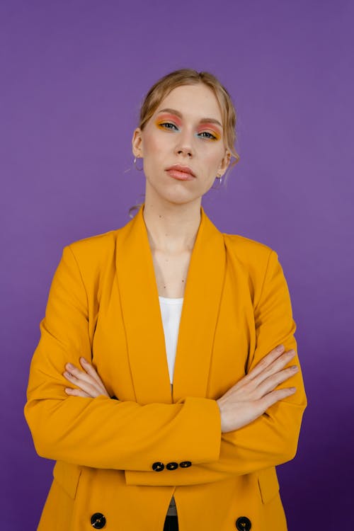 Free Woman in a Yellow Blazer Posing with Her Arms Crossed Stock Photo