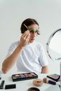 Woman in White Crew Neck T-shirt Wearing Green Framed Eyeglasses