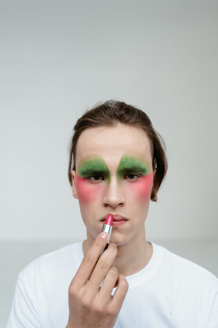 Man In White Shirt Applying Red Lipstick