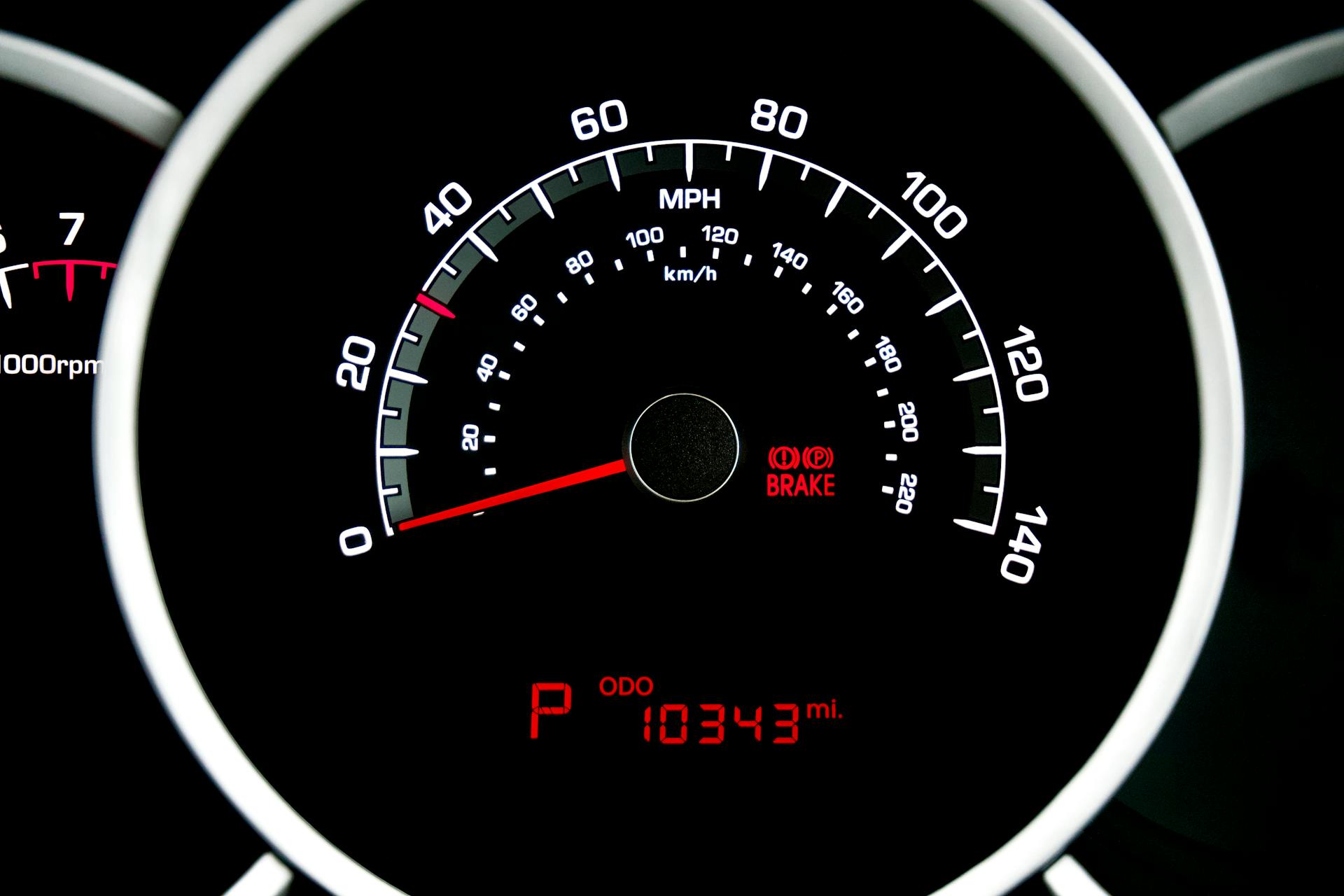 Close-up view of a car speedometer showing speed in MPH and odometer reading 10343 miles.