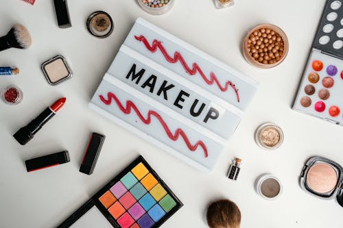 Makeup Kits Beside a Sign with Makeup Text