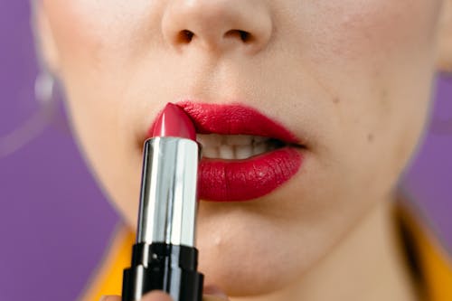 A Woman Applying Red Lipstick