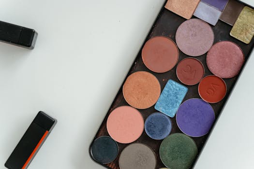 A colorful array of eyeshadows in a palette captured in a flat lay style, perfect for beauty and cosmetic themes.