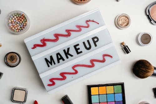 Makeup Kits Beside a Sign with Makeup Text
