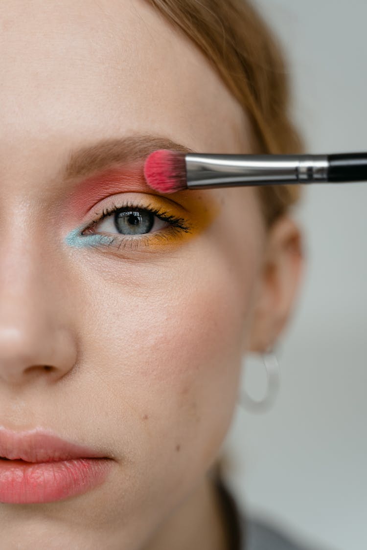 Woman Applying Pink Eyeshadow With A Brush