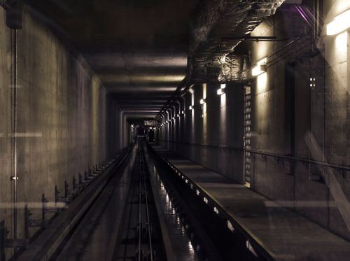 Free A dimly lit subway tunnel reflecting an industrial feel, showcasing modern transportation infrastructure. Stock Photo