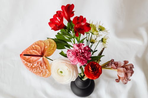 Assorted Flowers in Black Ceramic Vase