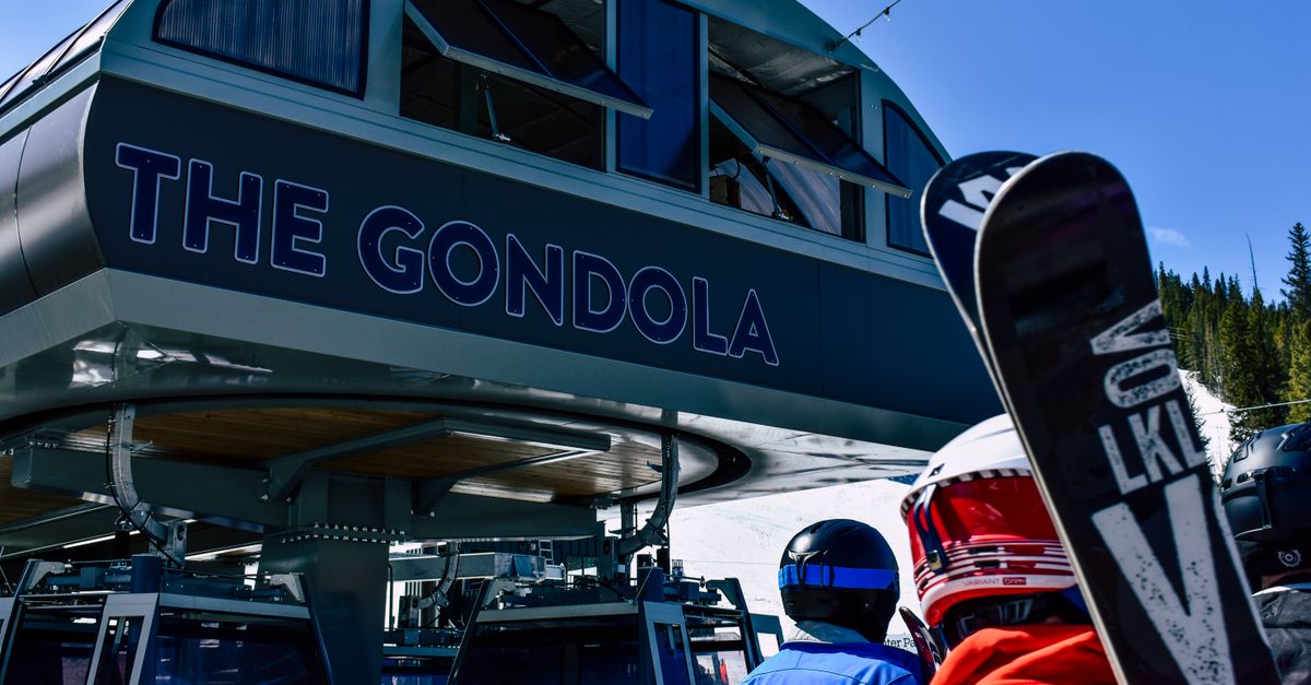 Skiers wait at the gondola station for skiing and snowboarding adventures in winter mountains.
