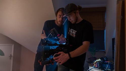 Men Filming Inside the Bedroom while Holding a Video Camera