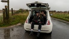 Man Sitting in Car Trunk