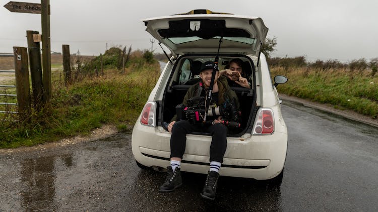 Man Sitting In Car Trunk