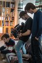 A Cameraman Filming an Artist while Sitting on the Couch