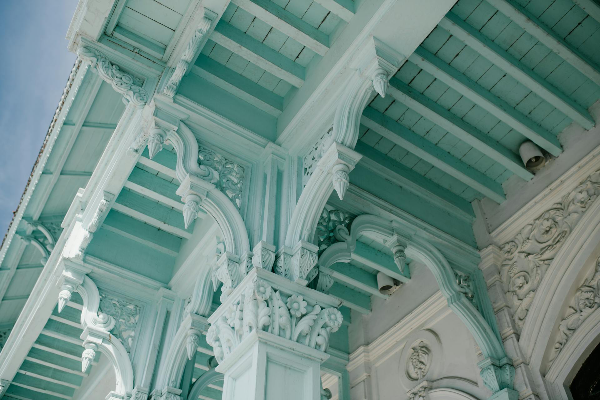 From below of majestic ornamental ceiling and columns of aged classic building in city