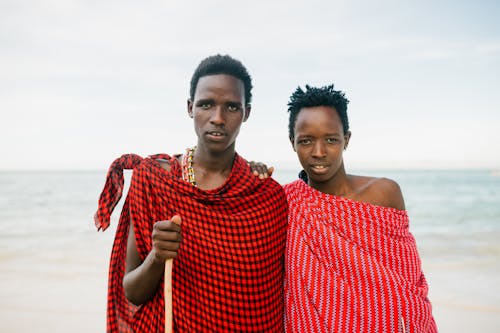 African father and son on seashore