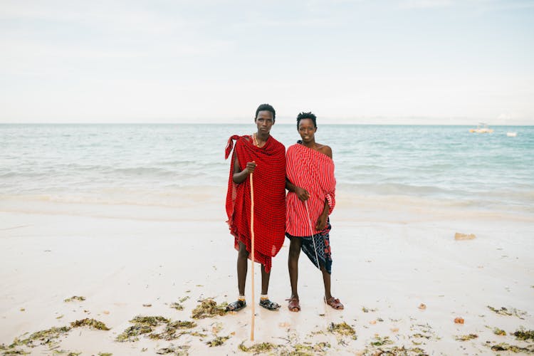 Ethnic Father And Son Standing On Beach