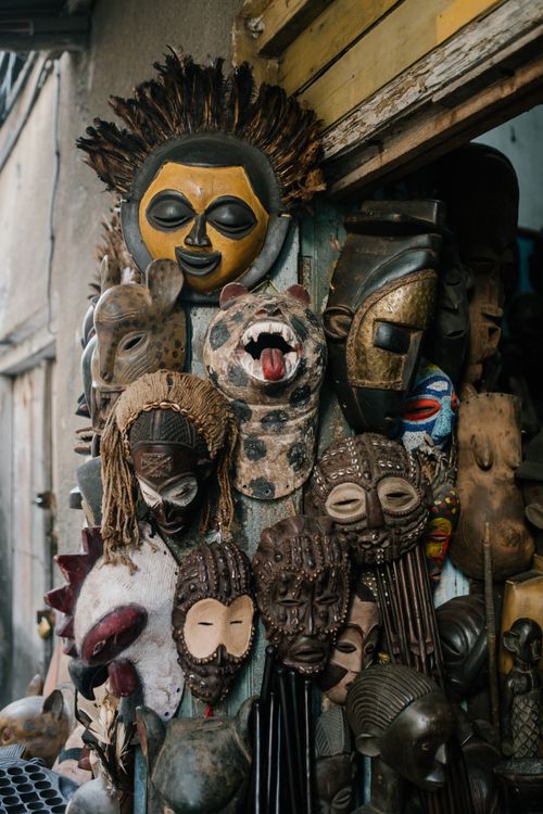 Free Assorted traditional African masks hanging near entrance in local souvenir shop in city Stock Photo
