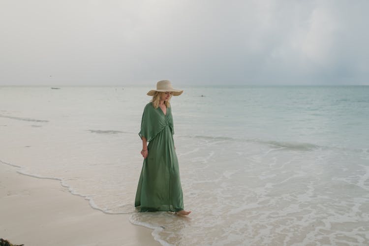 Woman Walking Along Seaside Washed By