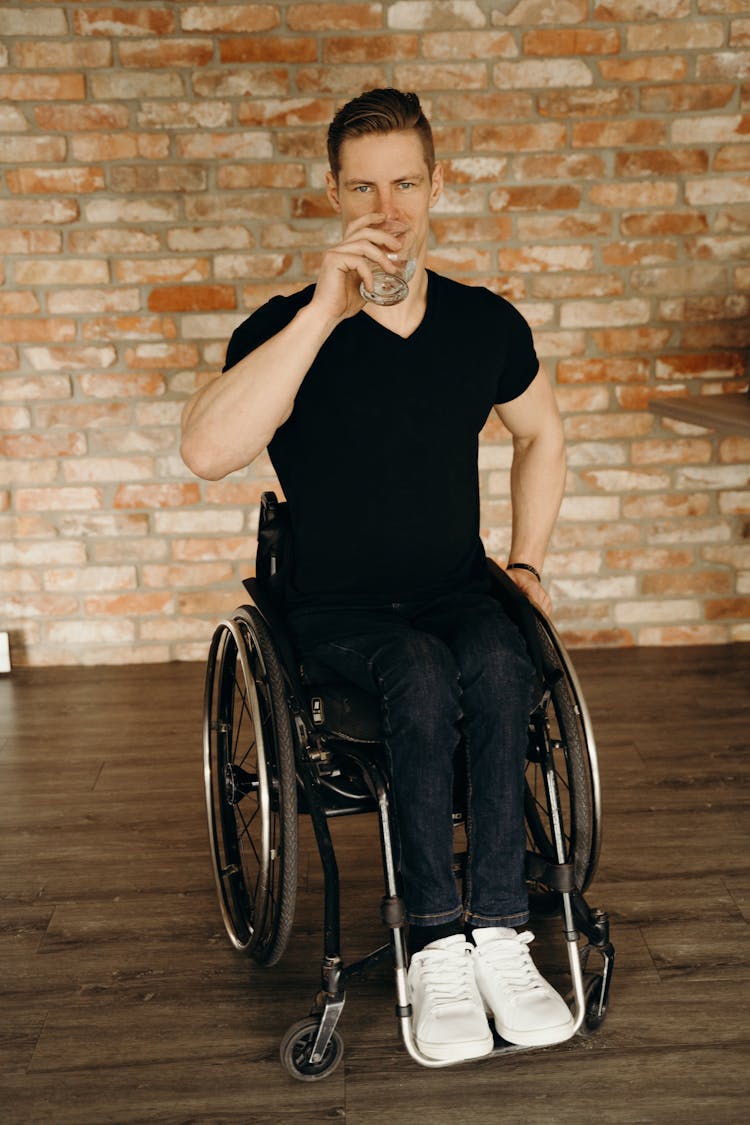 Man In Black Crew Neck Shirt Sitting On A Wheelchair