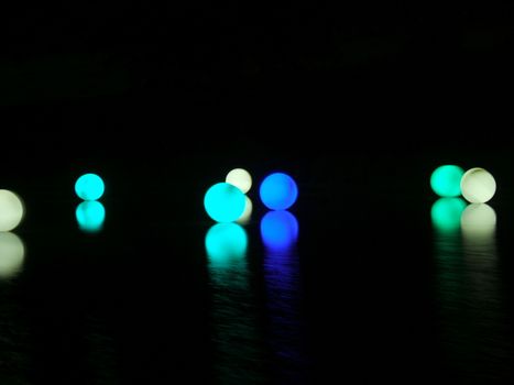 Colored Illuminated Sphere on the Water