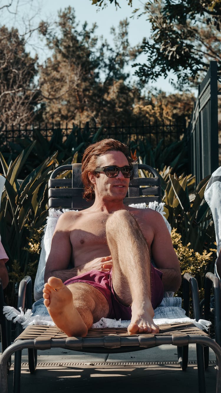 Man Relaxing On Sun Lounger