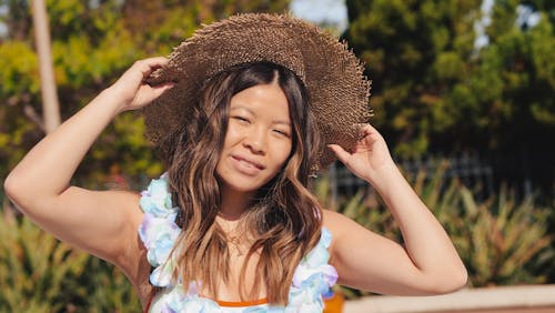 Woman Holding Her Sun Hat