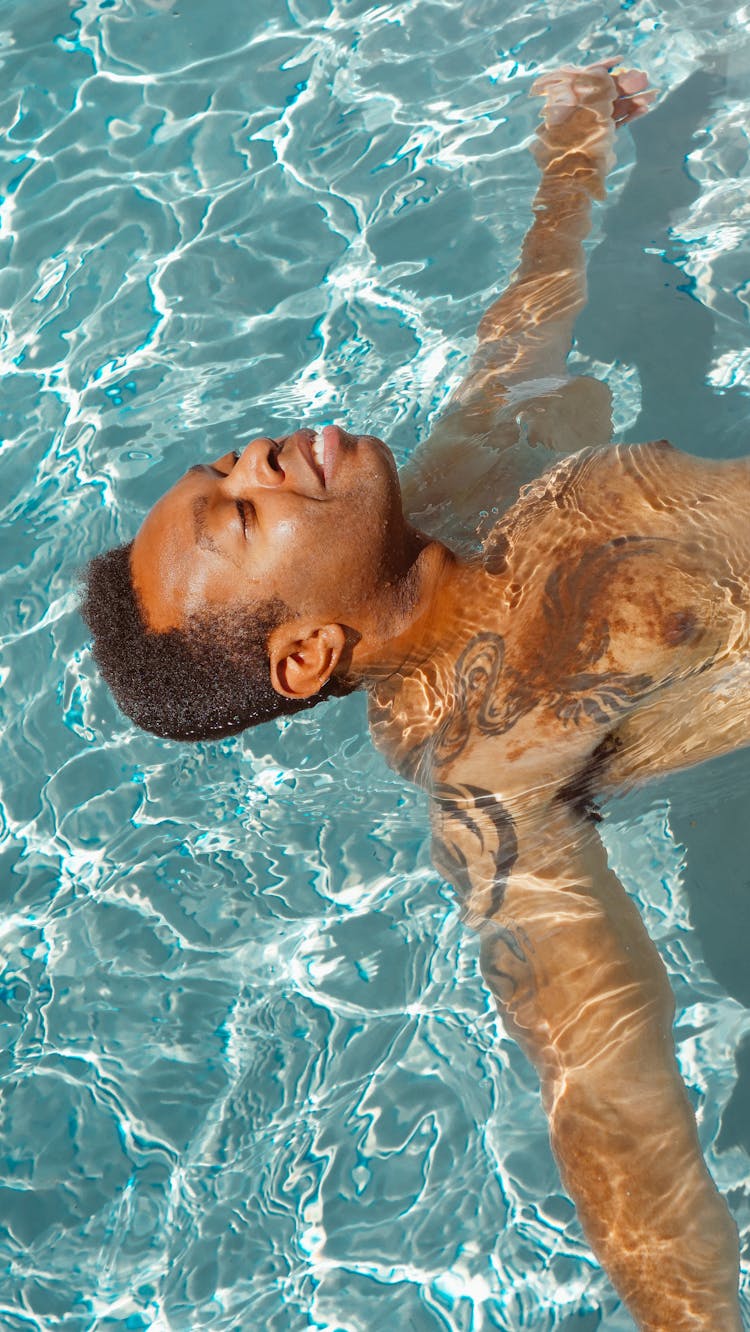 Man Relaxing In The Swimming Pool