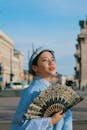Woman Holding a Hand Fan