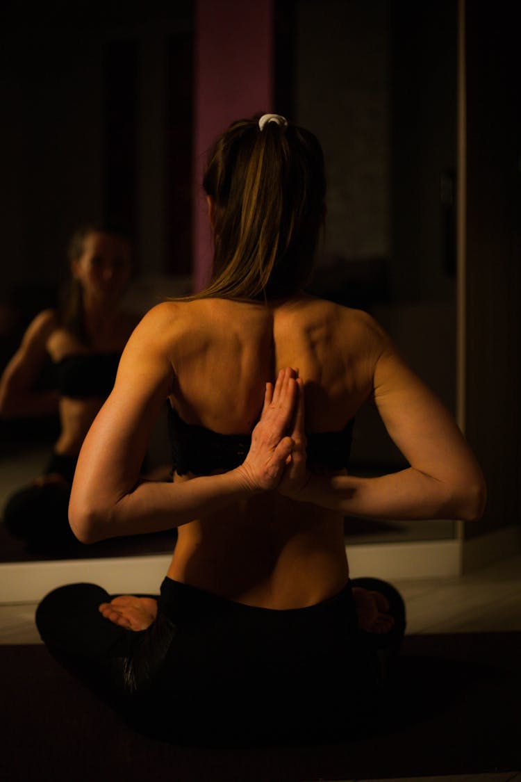 Woman In Black Sports Wear In Reverse Prayer Position