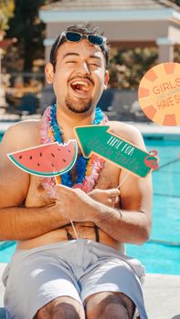 Man laughing joyfully poolside with summer decorations and signs.