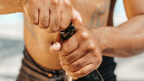 Close-Up Photo of Person Opening a Champagne Bottle