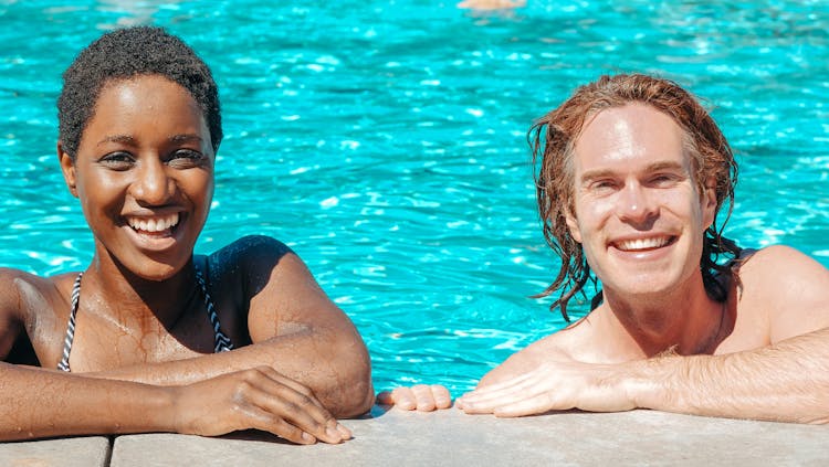 Man And Woman Smiling In The Swimming Pool