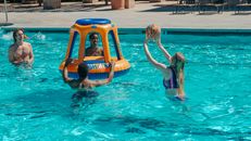 People Having Fun Playing Basketball in the Swimming Pool
